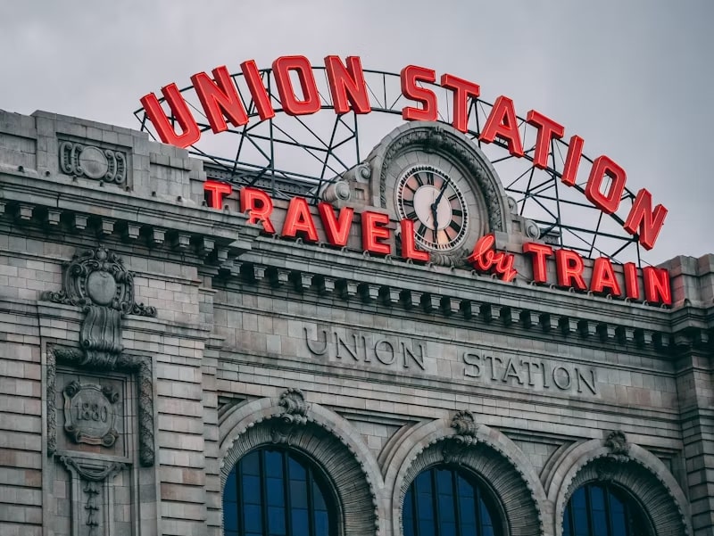 an image of the union station neon sign advising the travel by train