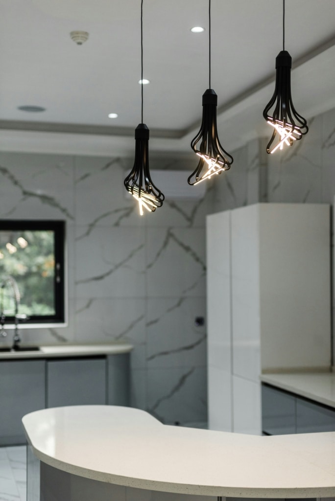 modern kitchen island with three hanging lights